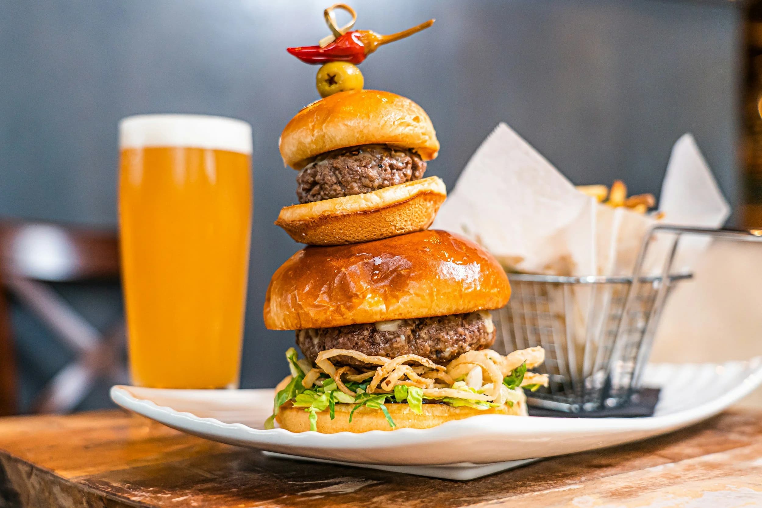 A craft beer poured alongside a plated dish